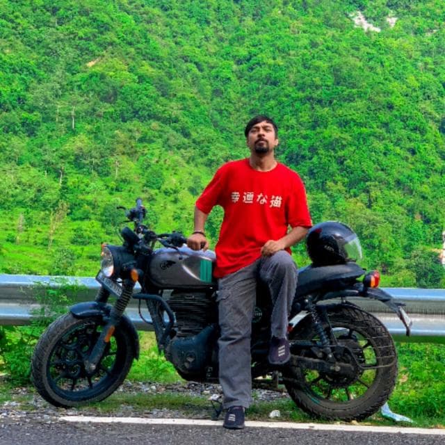 Anshul on a motorcycle trip through green mountains